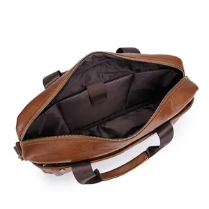 Brown leather briefcase interior detail, showing multiple compartments and laptop pocket.