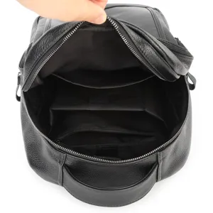 Genuine leather men's backpack interior detail showing large capacity compartments and zippered pockets.