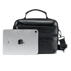 Genuine leather men's messenger bag detail view, showing large capacity and black texture.