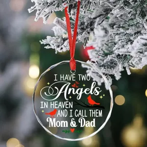 Close-up detail of round crystal Christmas memorial ornament with red cardinal bird and text.