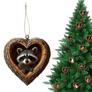 Detailed view of 2D acrylic heart-shaped tree house raccoon ornament hanging on Christmas tree.
