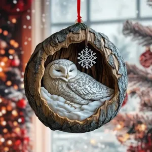 Christmas tree hanging ornament featuring a cute snowy owl inside a rustic tree hole holiday decor.
