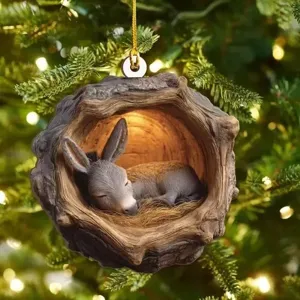 Close-up detail of the cute sleeping donkey inside wooden tree hollow Christmas ornament hanging.