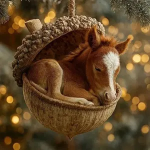 Close-up detail of the cute sleeping foal inside acorn ornament for festive Christmas tree.