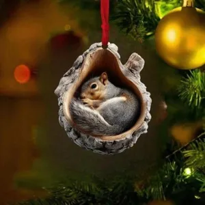 Christmas tree hanging ornament featuring a cute sleeping squirrel inside a realistic tree hollow.