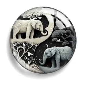 Round acrylic fridge magnet featuring a stunning black and white yin yang elephant design.