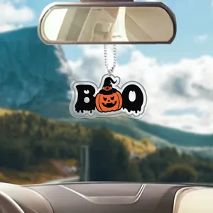 Halloween pumpkin acrylic car pendant detail, hanging in car interior rearview mirror scene.