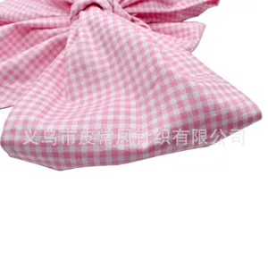 Pink gingham newborn swaddle sash bow detail, cute baby hair accessory and wrap decoration.