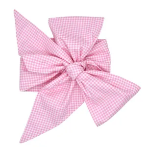Newborn pink gingham swaddle sash and bow decoration main product display isolated on white
