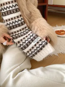 Close up of brown white fair isle knit scarf winter cozy texture fashion apparel detail view.
