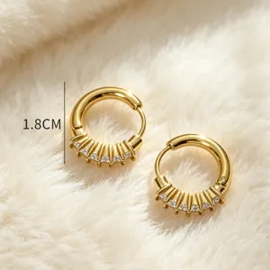 Detailed shot of 18k gold plated stainless steel cubic zirconia hoop earrings with floral design.