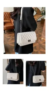 Detail shot of white quilted chain shoulder bag worn by model, showing stylish metallic lock.