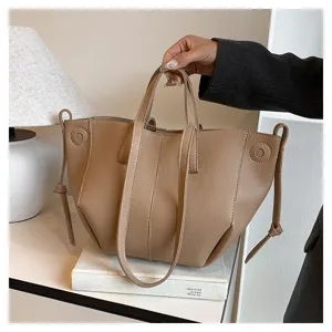 Detailed view of the stylish khaki leather tote bag showing wing gusset and handle.