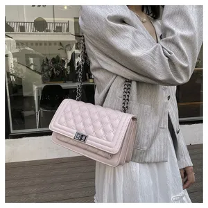 Pink quilted chain shoulder bag detail, stylish crossbody handbag with elegant metal strap.