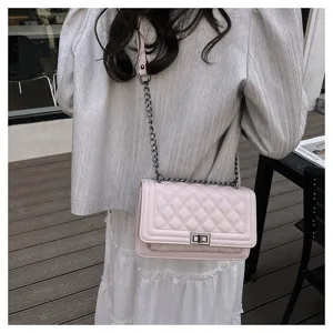 Detailed shot of a stylish pink quilted chain crossbody bag showcasing its elegant texture and design.