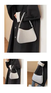 Silver metallic baguette shoulder bag, stylish underarm purse with sleek metallic finish.