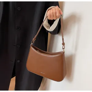 Brown leatherette baguette shoulder bag detail, elegant minimalist underarm style accessory.