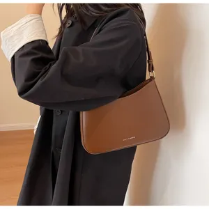 Retro brown PU leather baguette shoulder bag for women, stylish underarm bag detail view.