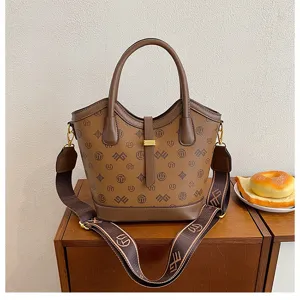 Detailed view of the vintage brown monogram bucket bag with top handles and straps.