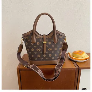 Retro fashion brown handbag with large capacity bucket design, shoulder strap and top handles.