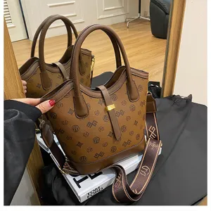 Vintage brown monogram bucket bag for women, stylish top handle shoulder crossbody bag.