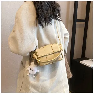Beige woven leather crossbody shoulder bag for women, stylish fashion handbag with cute charm.