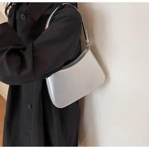 Stylish silver shoulder bag for women, chic baguette bag with sleek minimalist design.