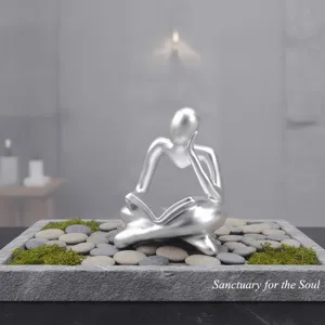 Detailed view of modern resin thinker reading statue, abstract sculpture for home desk decor.