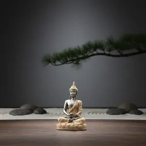 Mini zen buddha statue detail shot, resin sitting sculpture for peaceful home decor setup.