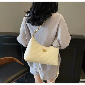 Chic white quilted shoulder bag with chain strap and turn-lock closure for women spring 2025.