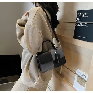 Color-block retro handbag detail view, stylish commuter crossbody bag with top handle for women.