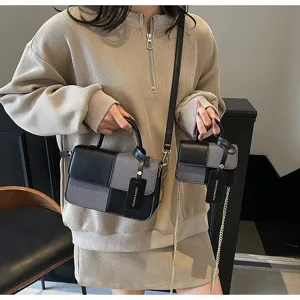 Close-up detail of the chic color-blocked handbag set featuring dual bags and stylish handle.