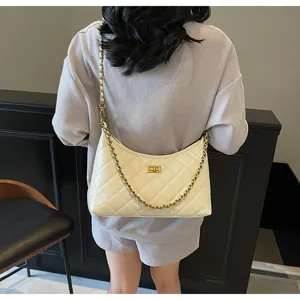 quilted chain shoulder bag detail view with metal twist lock and elegant dumpling shape