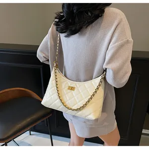 White quilted leather shoulder bag with gold chain strap, stylish dumpling hobo handbag.