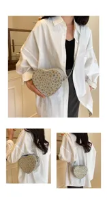 Detailed view of the stylish heart-shaped floral rhinestone chain bag worn by model.