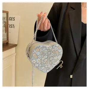 Detailed view of the sparkling floral heart-shaped chain crossbody bag with chic metallic strap.