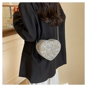 Stylish heart-shaped floral crossbody bag for women, chic chain shoulder bag for daily outfit.