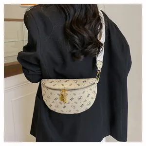 Chic beige crescent chest bag with cute bear print and gold hardware, trendy crossbody design.