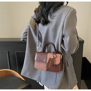 Detail view of stylish color-blocked retro crossbody handbag, premium texture and chic design.