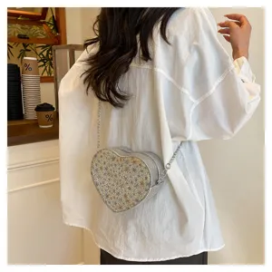 Rhinestone heart crossbody bag with silver chain strap, stylish shoulder handbag for women detail.