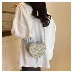 Stylish floral heart-shaped chain bag for women, chic crossbody shoulder bag detail view.