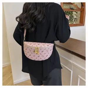 Pink chest bag with cute bear pendant and printed design, stylish crossbody waist bag detail.