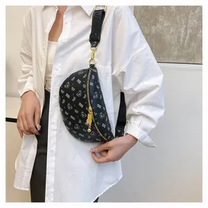 Close-up detail of the stylish black chest bag featuring cute bear prints and gold hardware.