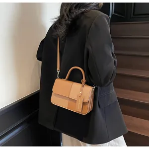 Detailed view of the color-block retro crossbody bag with textured fabric and leather.