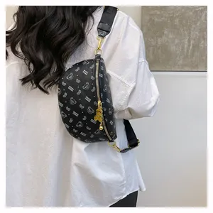 Detailed view of stylish black chest bag featuring cute bear print, gold hardware and zipper.