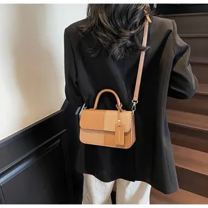 Detail view of a retro color-block women's small shoulder bag featuring top handle and strap.