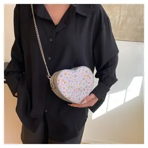 Detailed view of a sweet floral heart-shaped crossbody bag with chic chain strap.