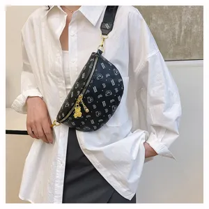 Detailed shot of a stylish black chest bag featuring a cute bear pattern, gold zipper, and pendant.