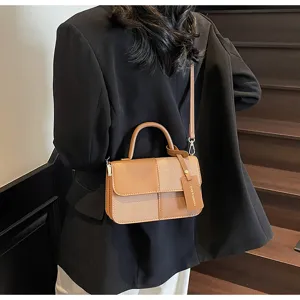 Detail view of stylish colorblock retro small crossbody handbag, premium commuter design.