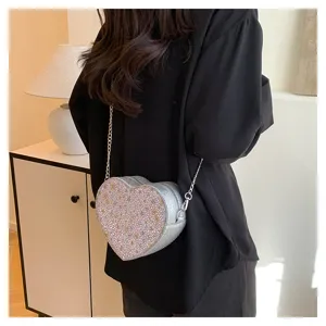 Detailed view of fashionable heart shaped glitter chain crossbody bag with metallic strap.